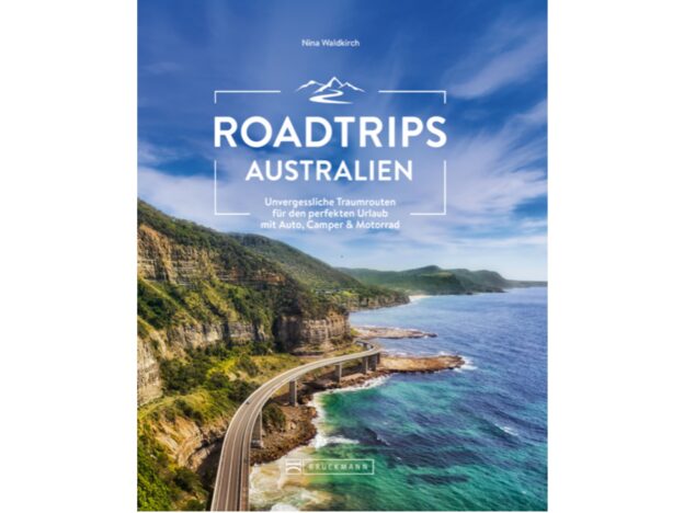 Cover „Roadtrips Australien – Unvergessliche Traumrouten für den perfekten Urlaub mit Auto, Camper & Motorrad“ von Nina Waldkirch: Tiefblaues Wasser und schroffe Klippen unter blauem Himmel